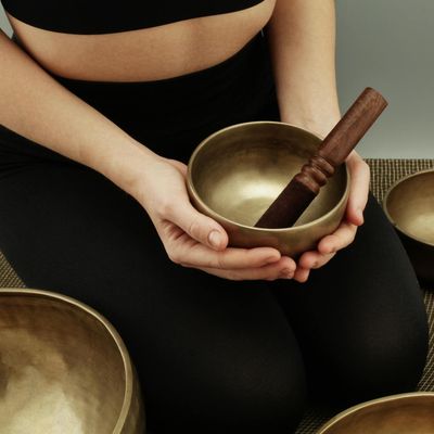 A person sitting in a meditative pose at the end of a session.